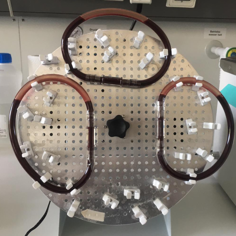 A homemade machine in the lab that moves three tubes filled with blood.