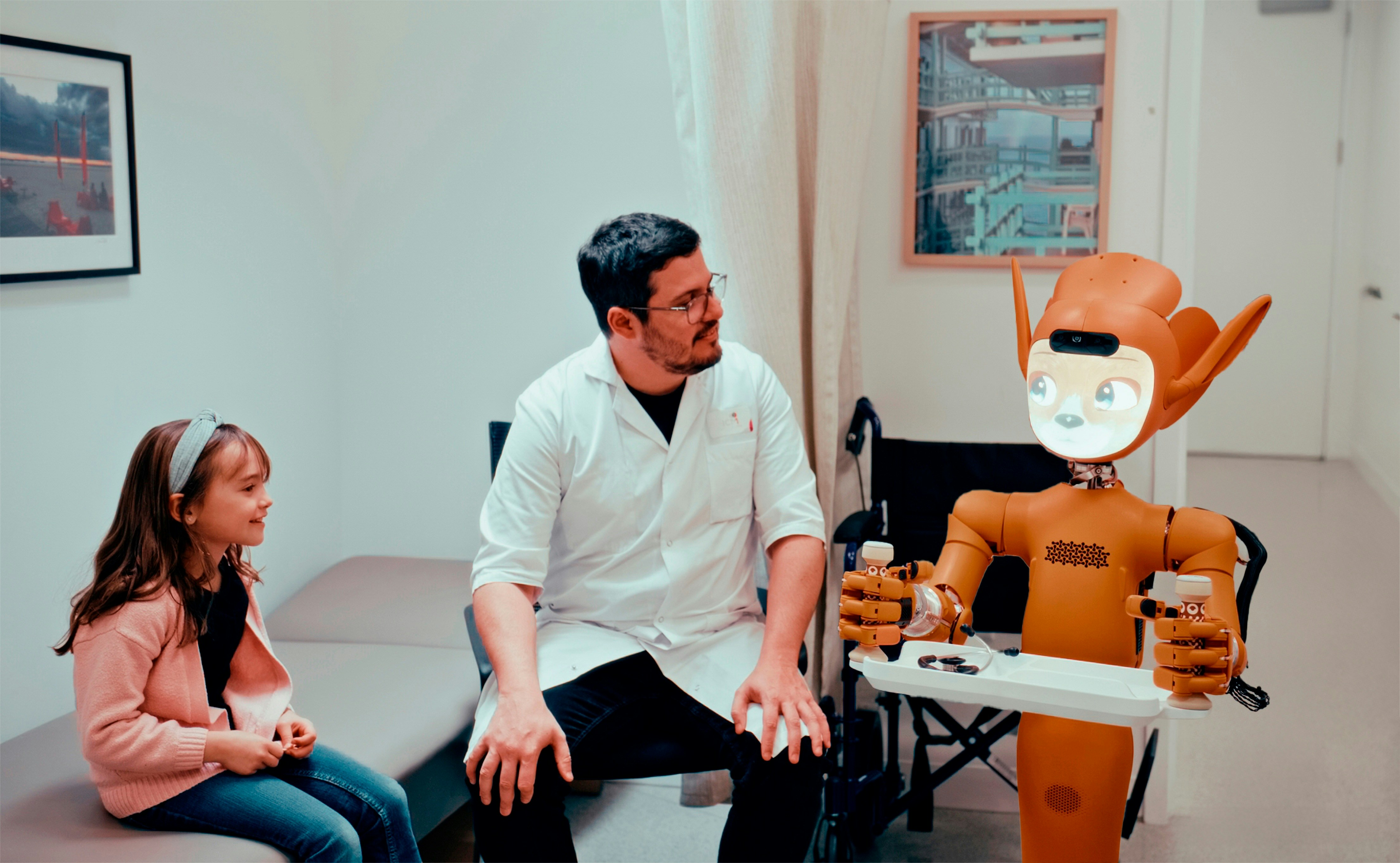 Next to a girl sitting on a treatment couch and a man in a white coat stands an orange robot holding a tray with a stethoscope on it.