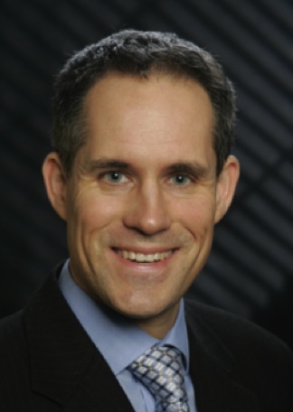 Portrait of scientist against black background.