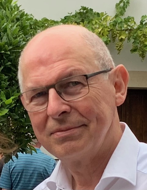 Portrait of a man with glasses and a white shirt