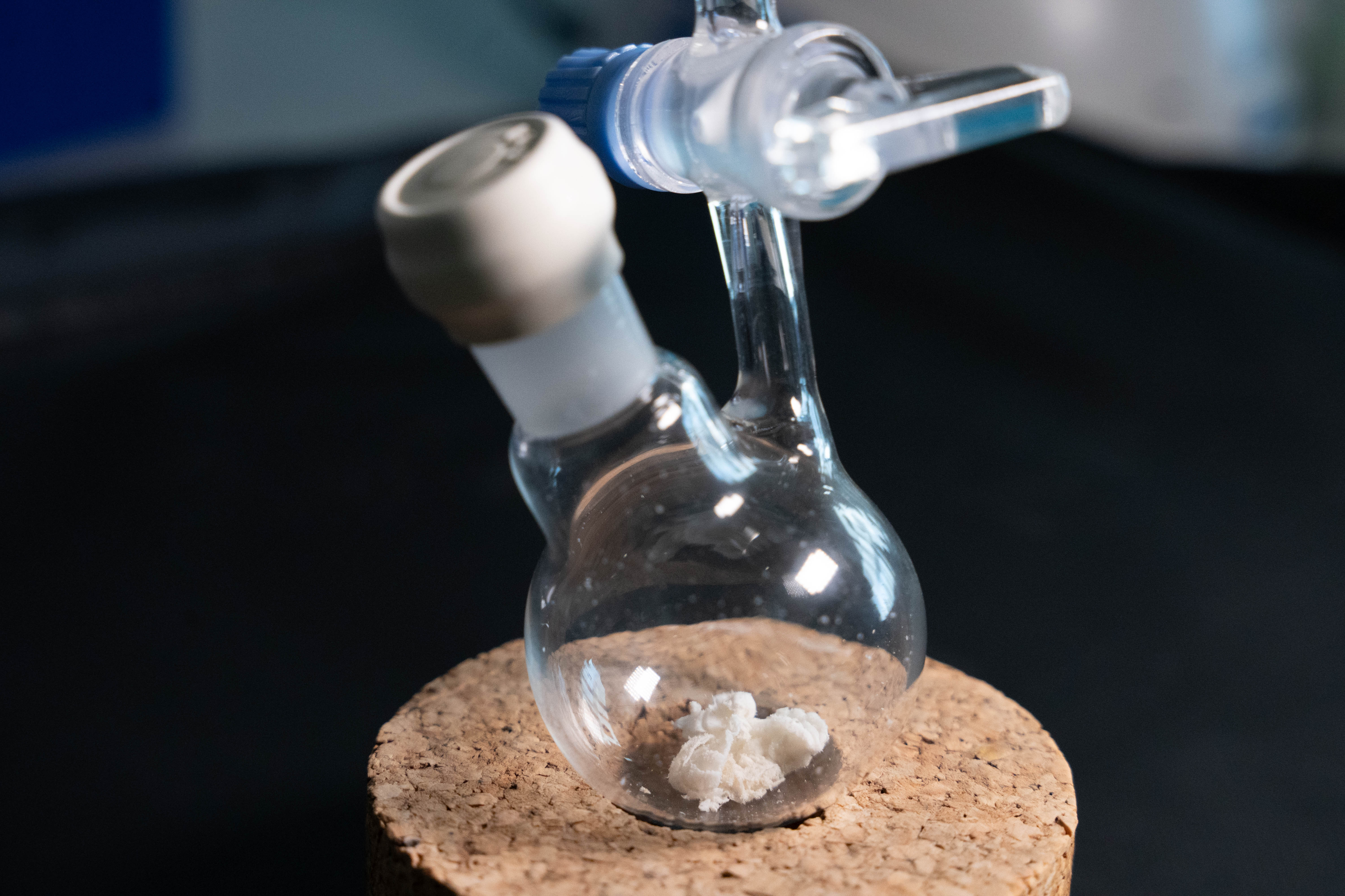 Close-up of a glass flask containing the white powdered antibiotic epifadin.