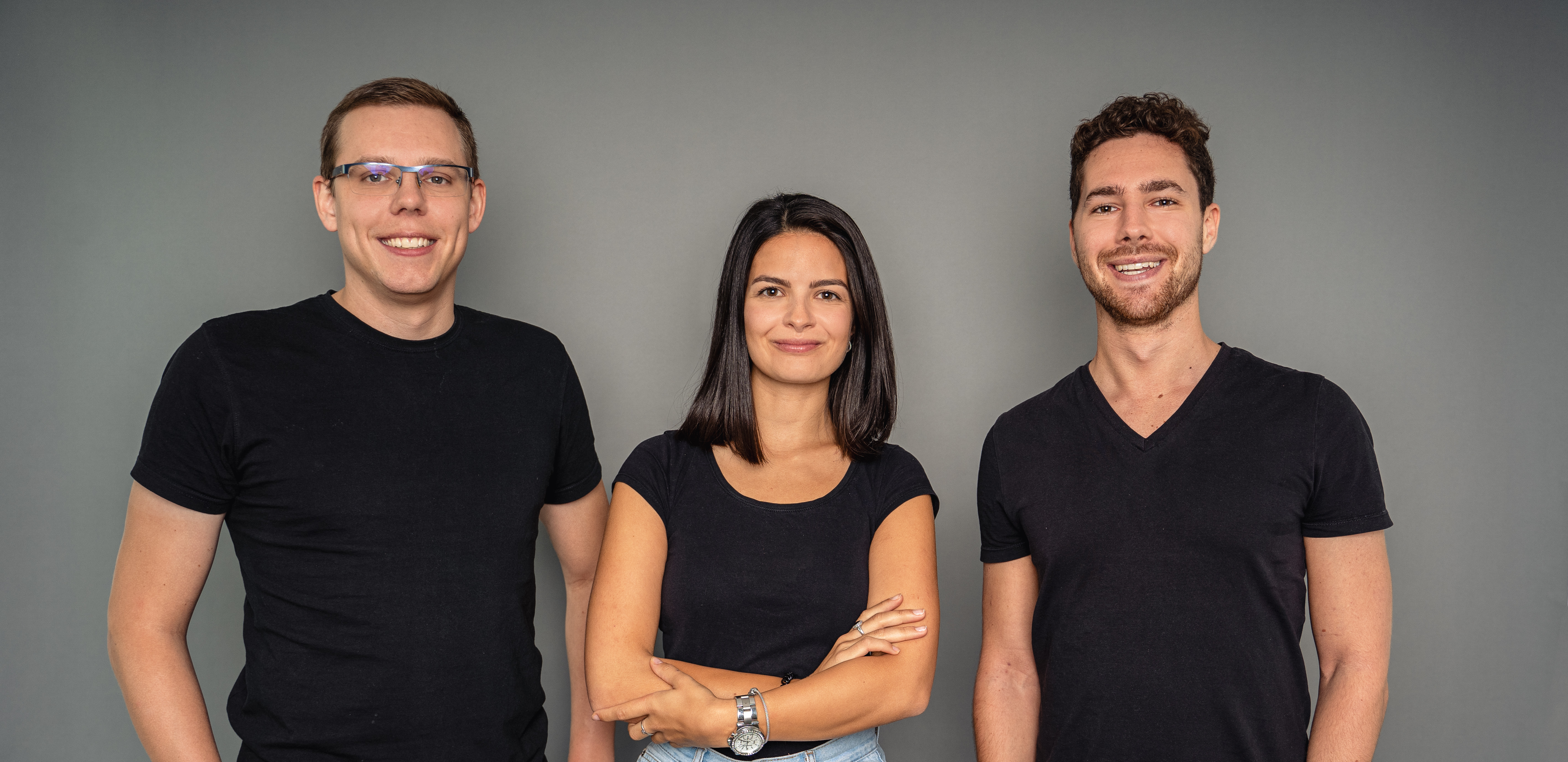 Two young men and a young woman in black T-shirts. They are the team of living brain, a start-up company that deals with virtual reality for cognitive diseases.