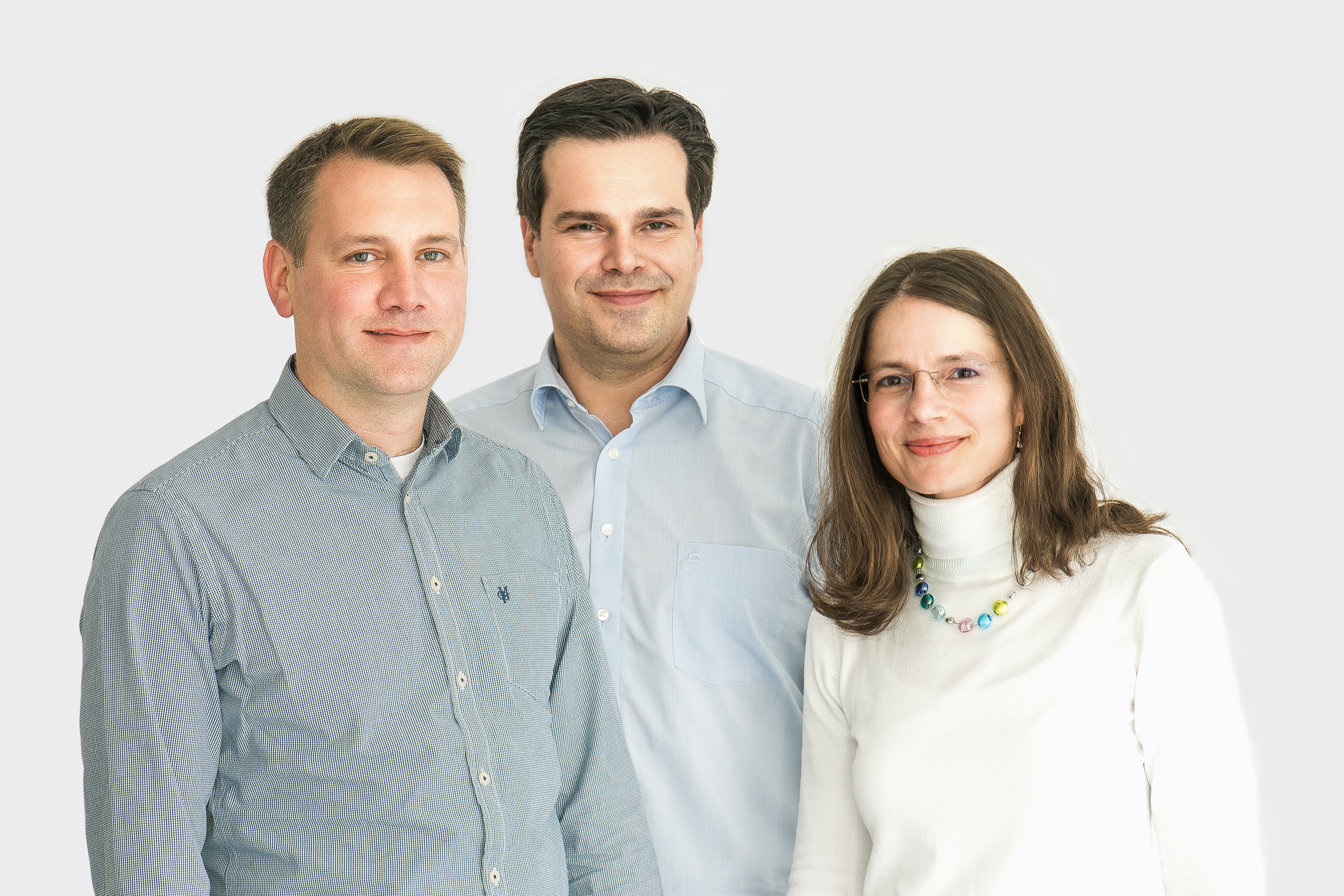 Gruppenfoto des Gründerteams. Zu sehen sind zwei jüngere Männer in hellblauen Hemden und mit kurzen Haaren sowie eine Frau mit langen dunklen Haaren im weißen Rollkragenpullover.