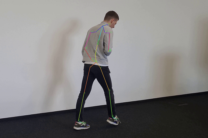 You can see a test subject whose skeletal position is visualized while walking with the help of colored markers.