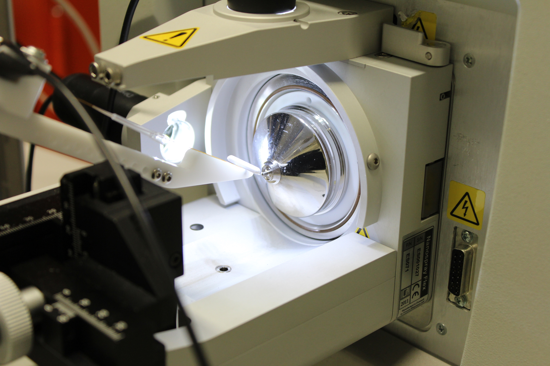 The photo shows the ion source of a mass spectrometer.