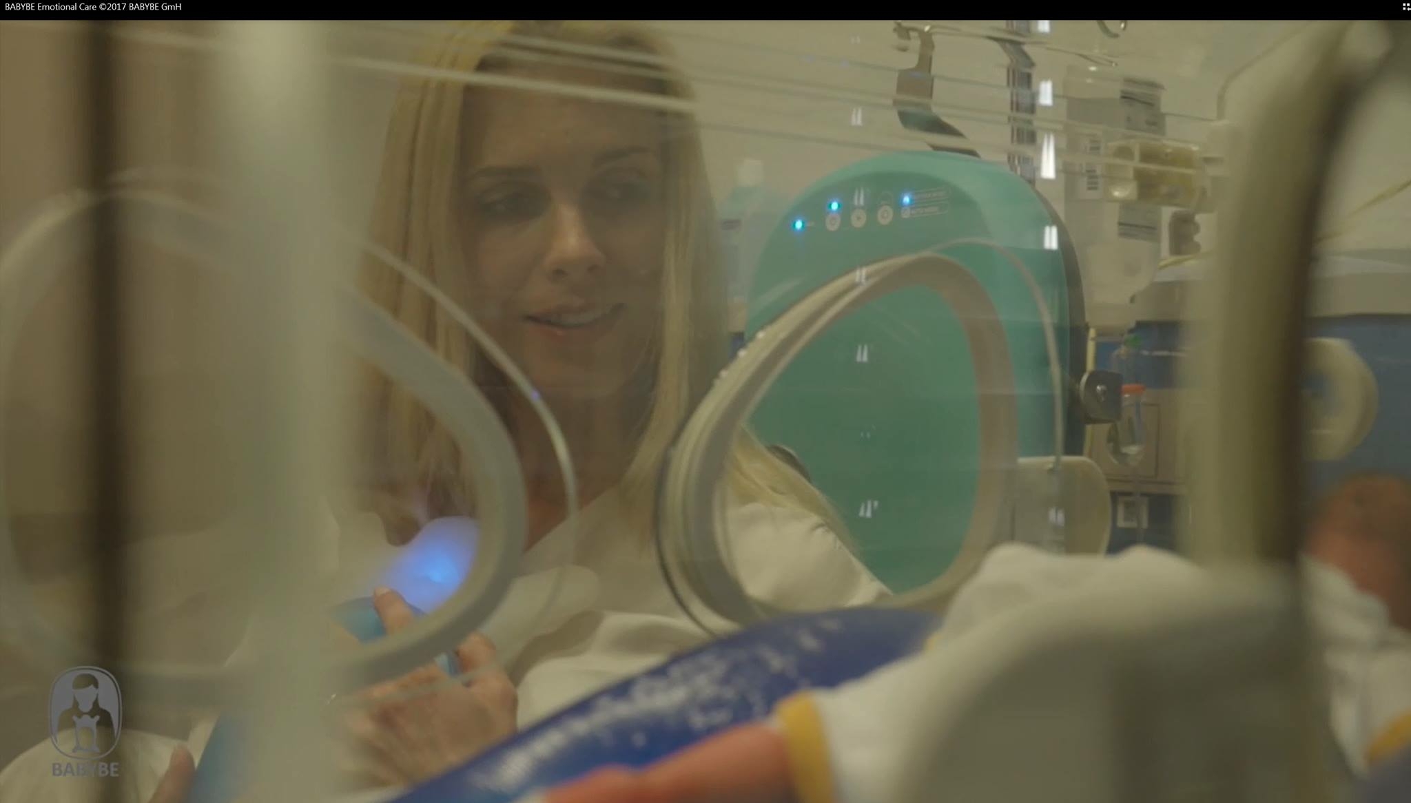 Gesicht einer Mutter, die vor einem Inkubator sitzt.