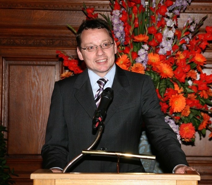 Photo of Prof. Martin Schaller wearing a suit and a tie, giving a talk.