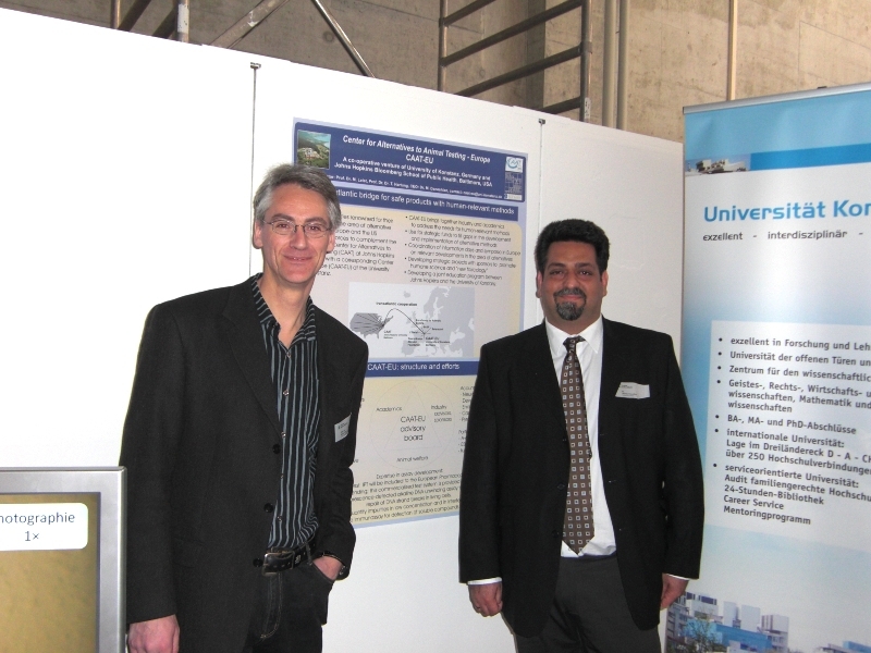 Prof. Marcel Leist, head of CAAT-EU and Dr. Mardas Daneshian, managing director of the new competence Centre for Alternatives to Animal Testing at the University of Constance, standing in front of a poster.