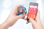 The left hand holds a smartwatch, the right one a smartphone. Data can be transferred between the two devices.