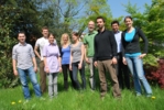 The photo shows 9 young people in a garden.