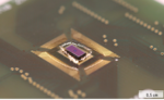 Close-up of the silicon chip (purple), which is connected to the sensor board by fine gold wires.
