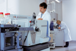Discovery team members checking the settings of a mass spectrometer.