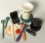 The photo shows several plastics products: tent pegs, a lid of a feeding coup, a small red bottle lid, a knife, a cosmetics container, two razers, a cup, a lipstick casing and a powder container.