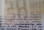 You see a 50 Euro note and the catchword "wissen" (knowledge) in a german dictionary.
