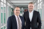 Photo showing the two CEOs, Dr. Frank Mathias and Michael Scholl.