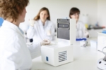 A laboratory device being loaded with small reaction vessels.