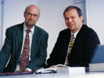Two men sitting at a table.