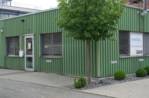 The photo shows a green building.