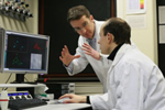 Prof. Dr. Christof Hauck and one of his colleagues in front of a computer.