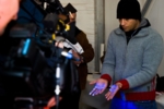 Die Hände eines jungen Mannes werden mit einer UV-Lampe beleuchtet