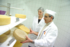 The photo shows food scientists evaluating different cheeses.